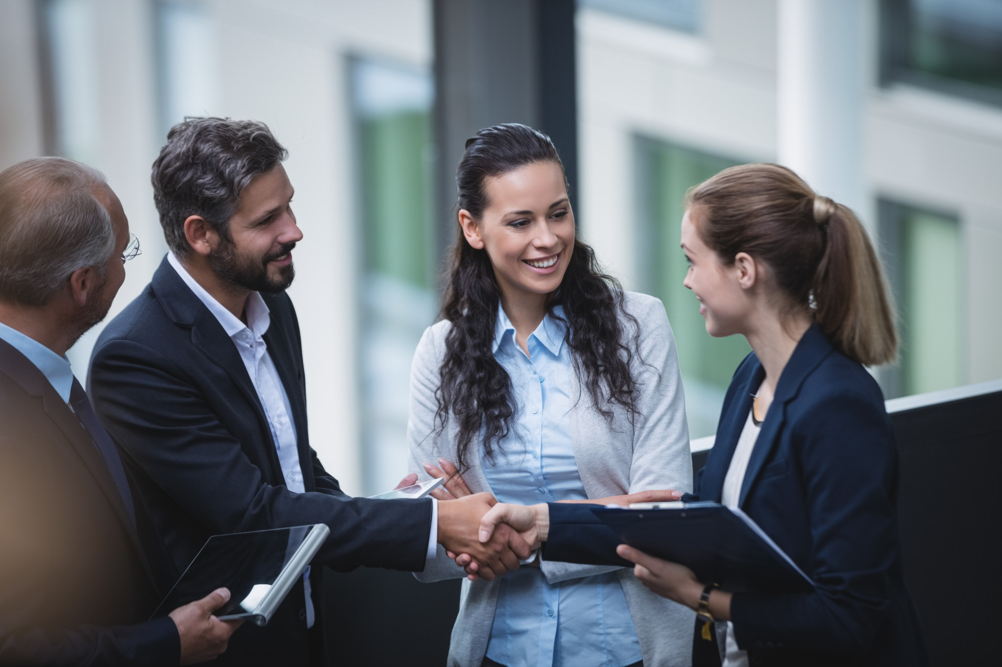 Group of businesspeople smiling and interacting