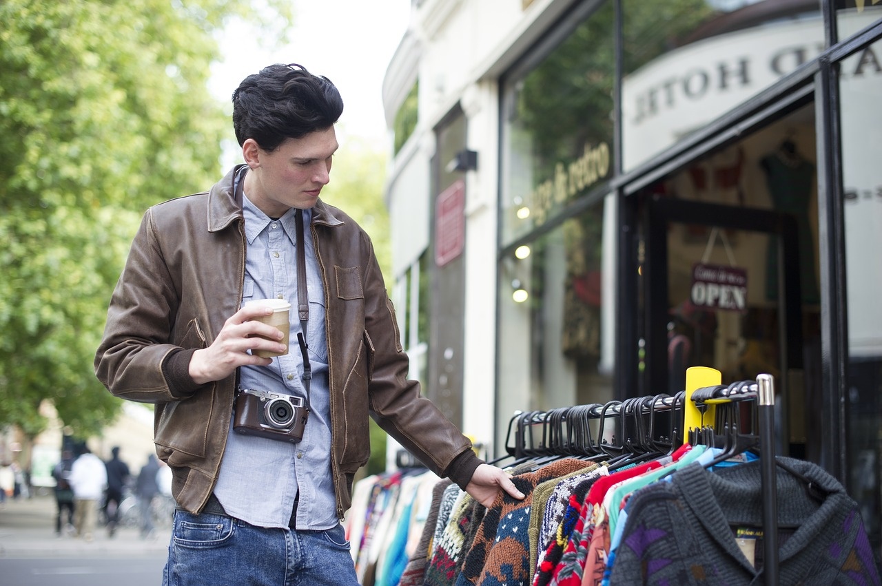 Bargain Hunter Looking at Sweaters Outdoors