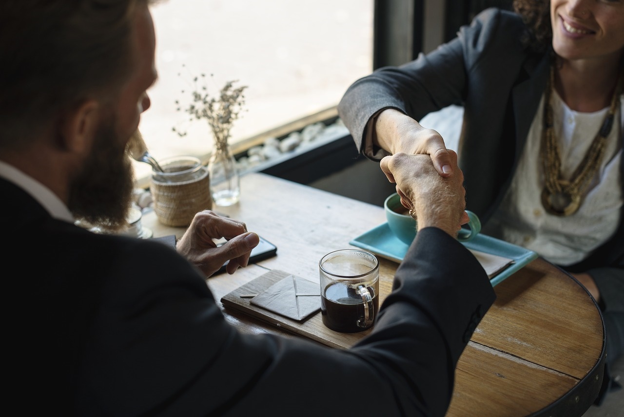 Businesswoman and Businessman Closing a Deal