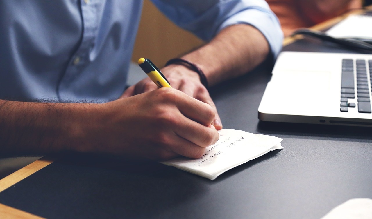 Man Writing Notes for a Business Plan