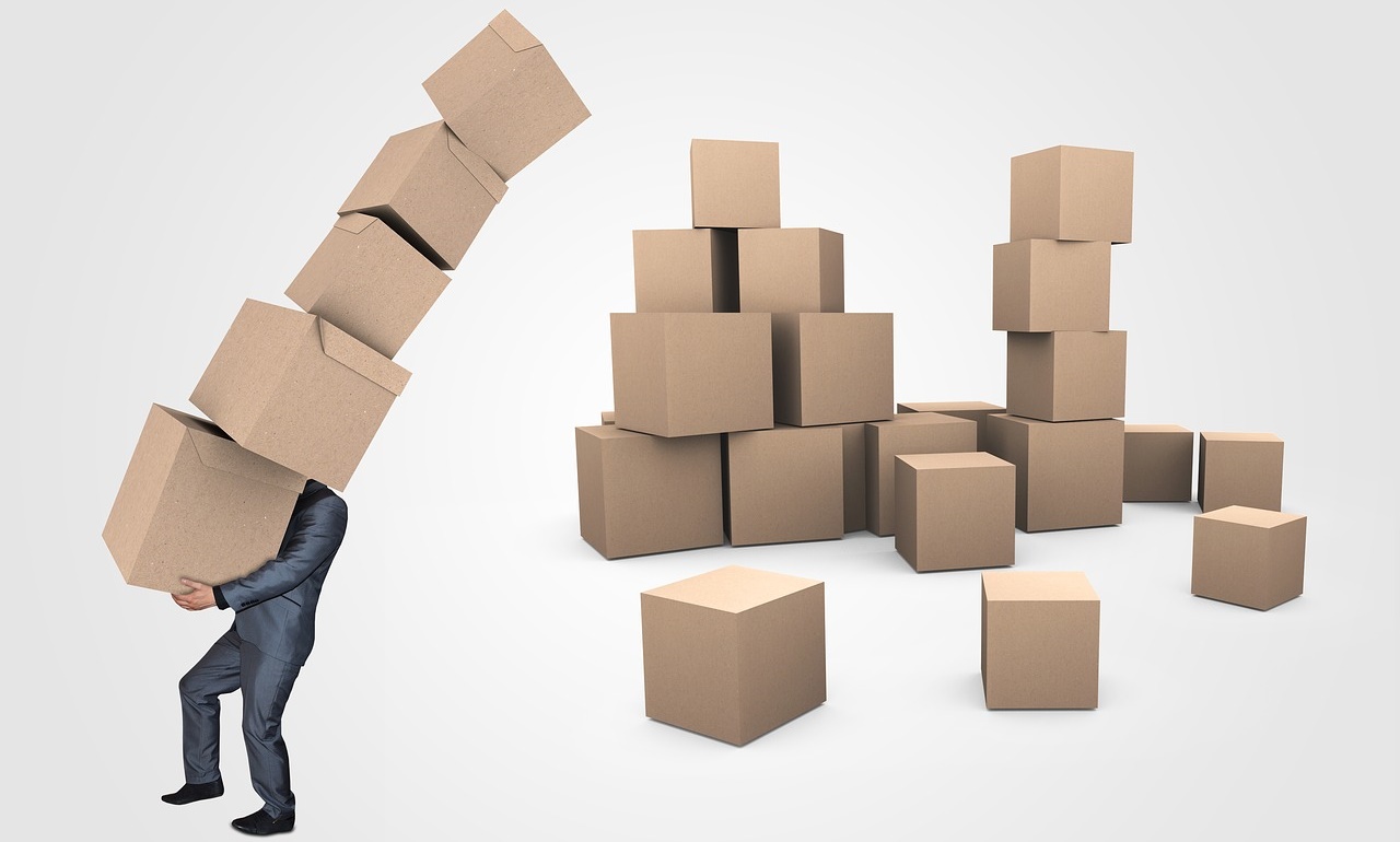 Businessman Carrying a Huge Stack of Teetering Boxes