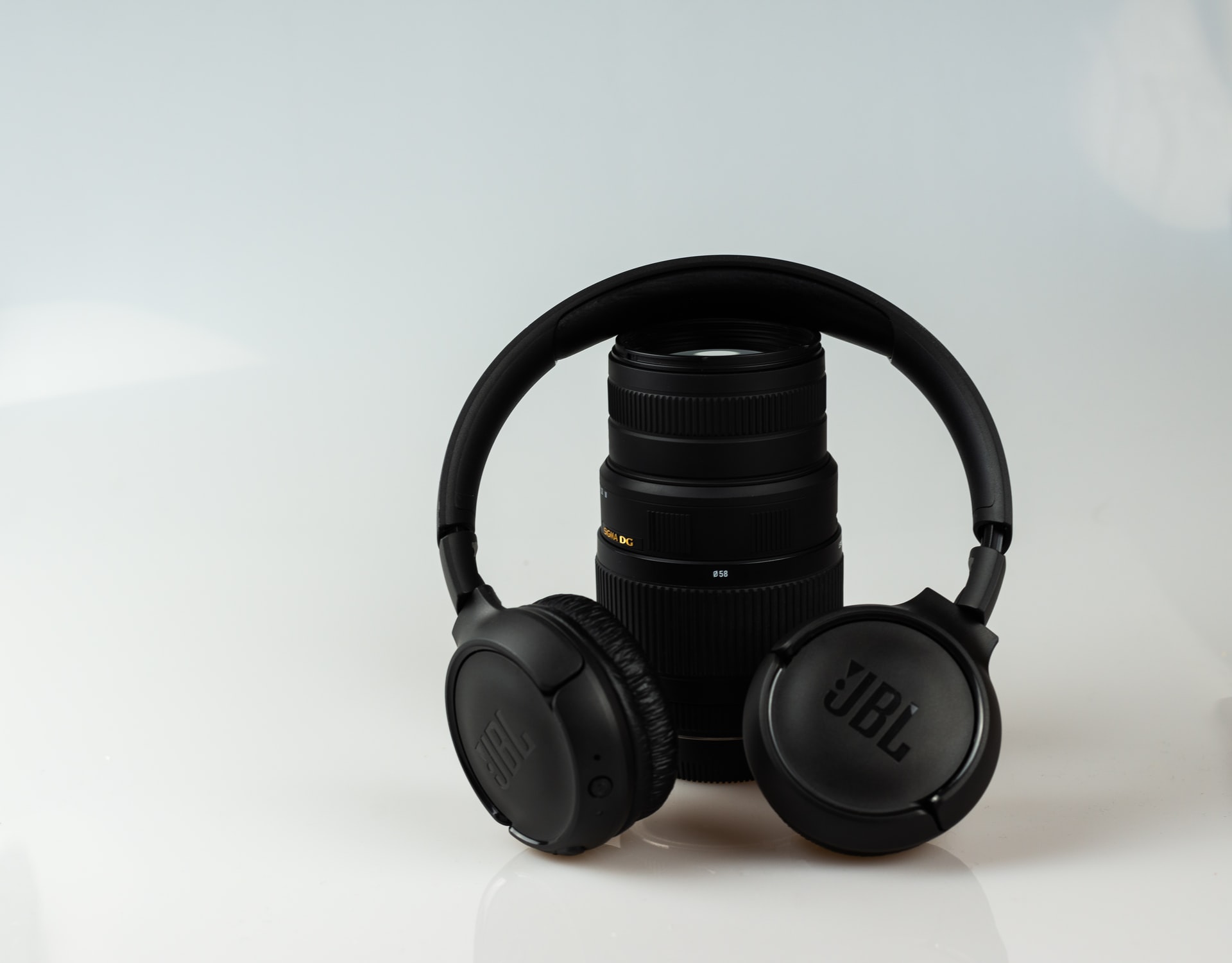 Black headphones and a black camera lens