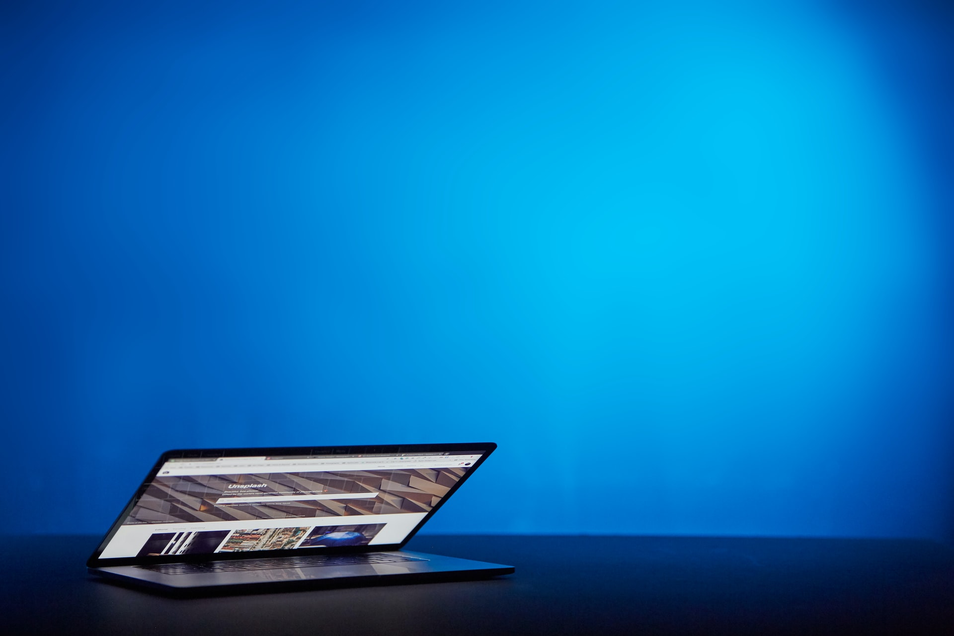 A laptop placed on a blue background