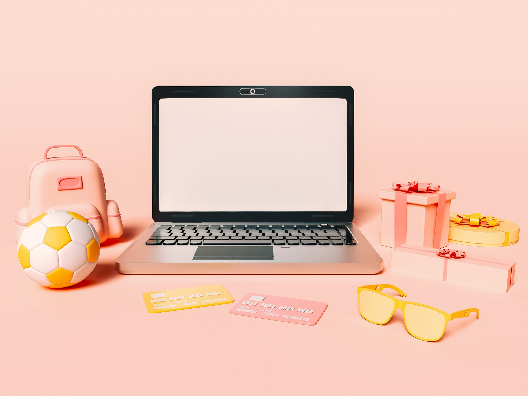 Laptop, backpack, football and a few gift boxes placed on a pink background