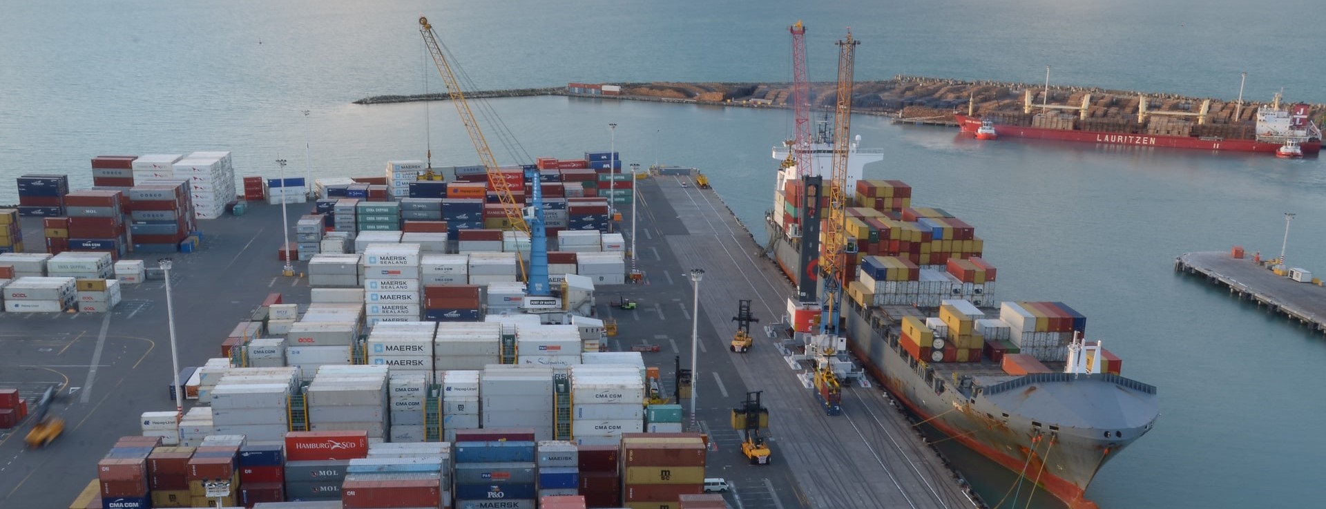 Ship docked to receive shipping containers