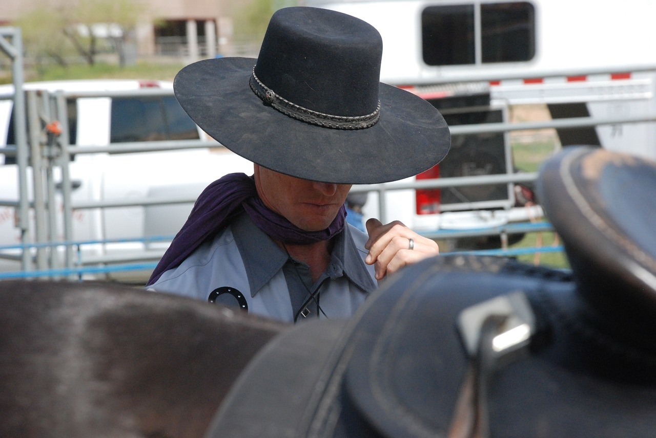 Cowboy in Black Hat Preparing for a Rodeo