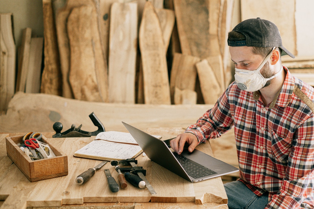 Man looking at a computer in a woodshop