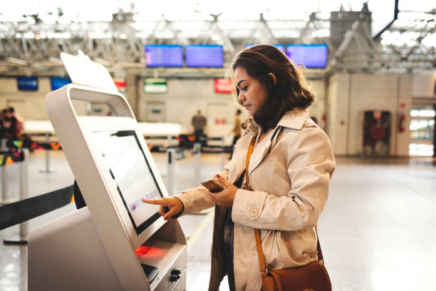 A woman using self-service via a touch screen