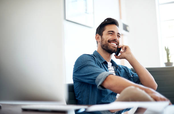 A man talking on the phone happily