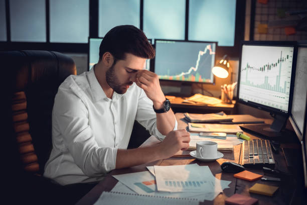 A worried man sitting in front of his work desk