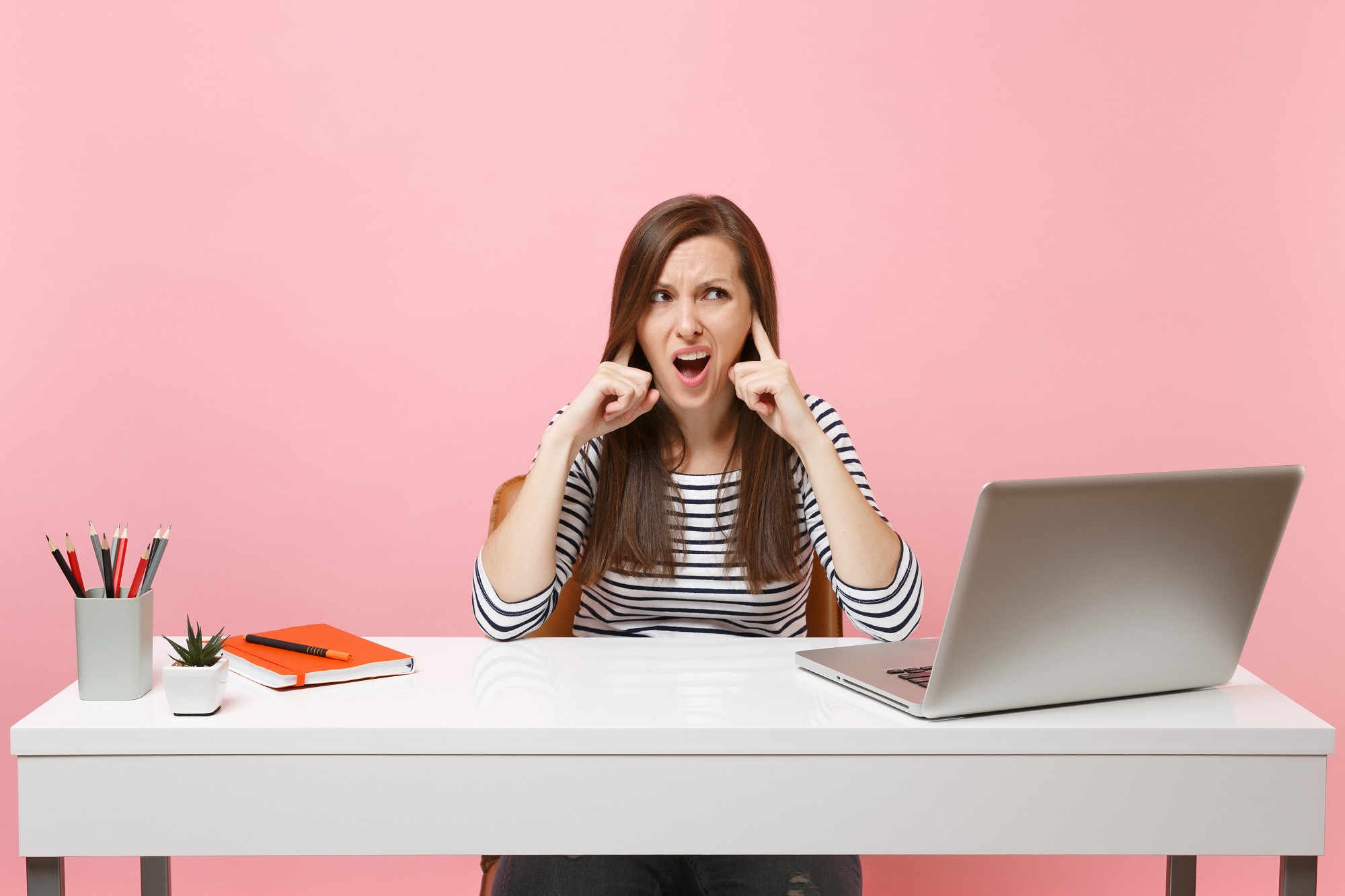 Frustrated woman with a laptop on a work table