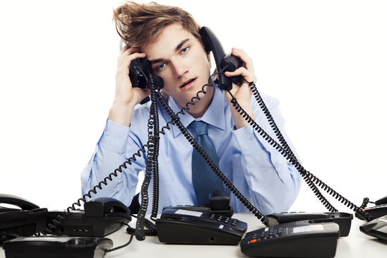 Exhausted Customer Service Agent Answering Several Phones at Once
