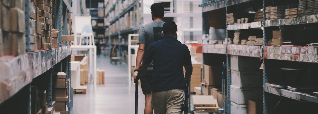 Men on a trolley in warehouse