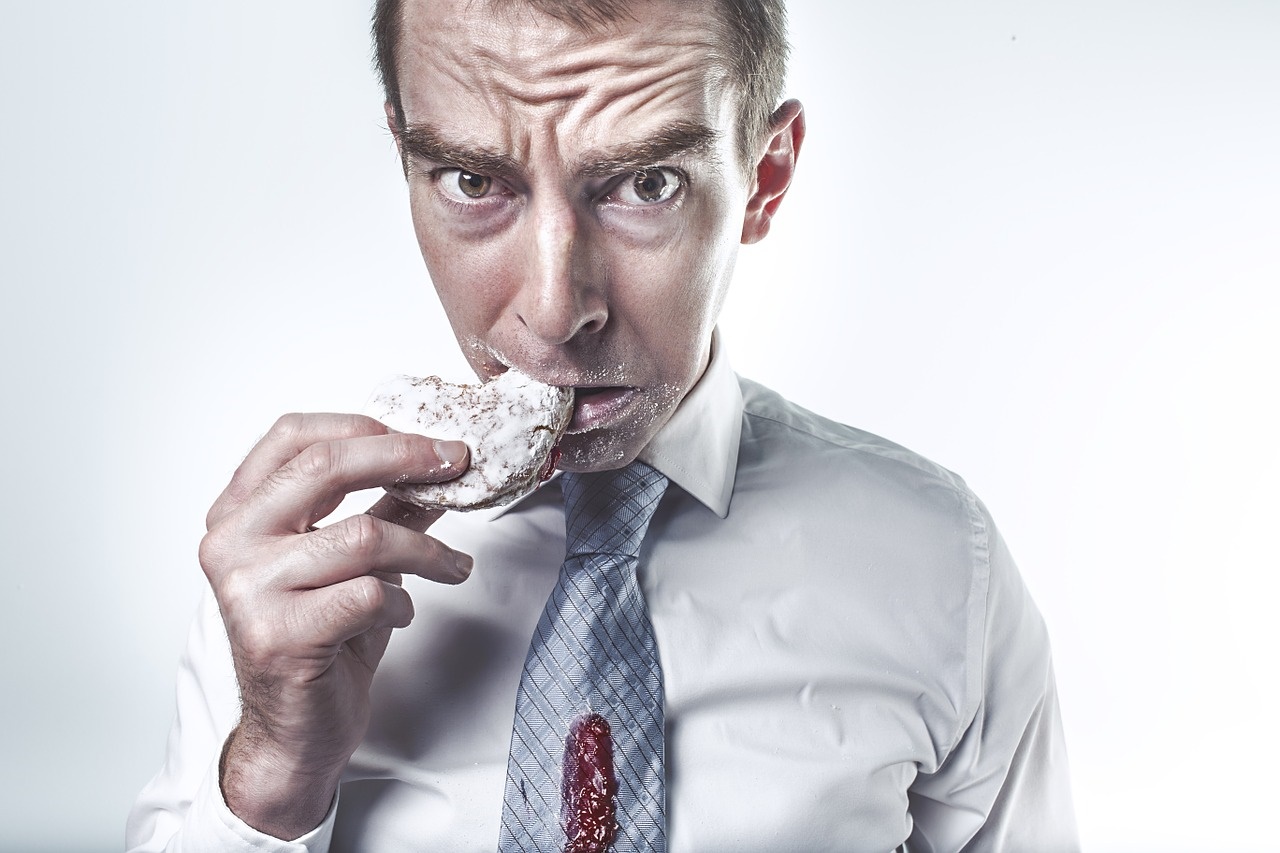 Businessman Messily Eating a Jelly Donut