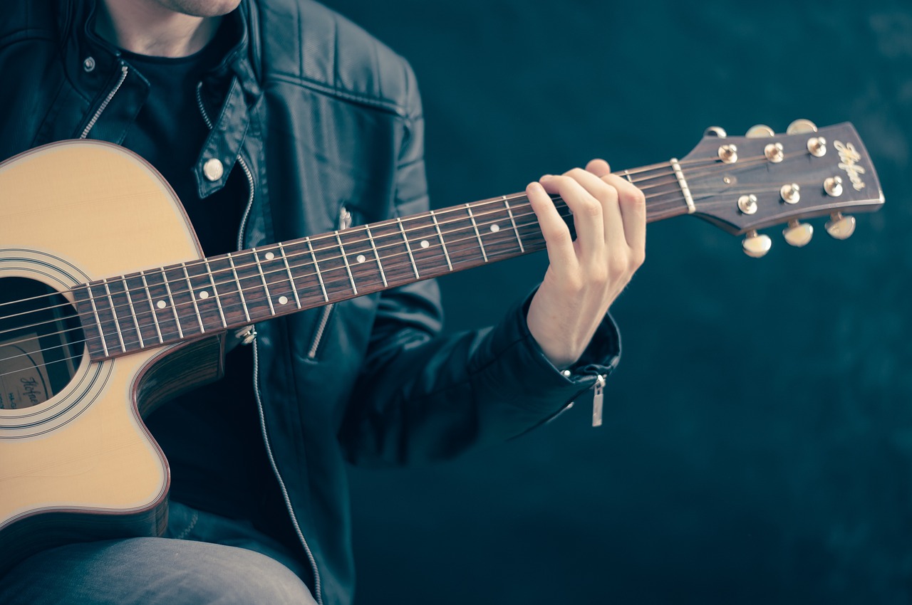 Playing Acoustic Guitar in a Leather Jacket