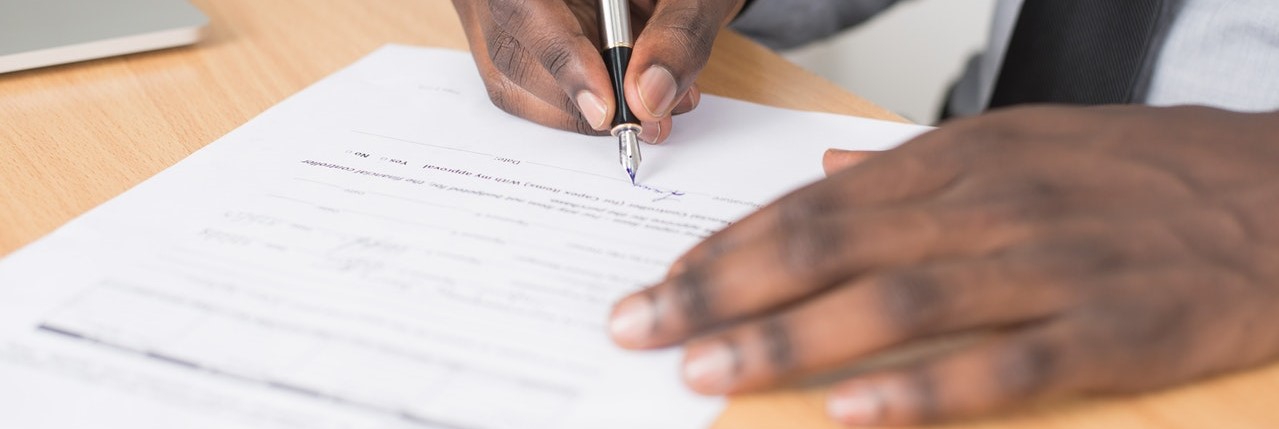 Man signing document