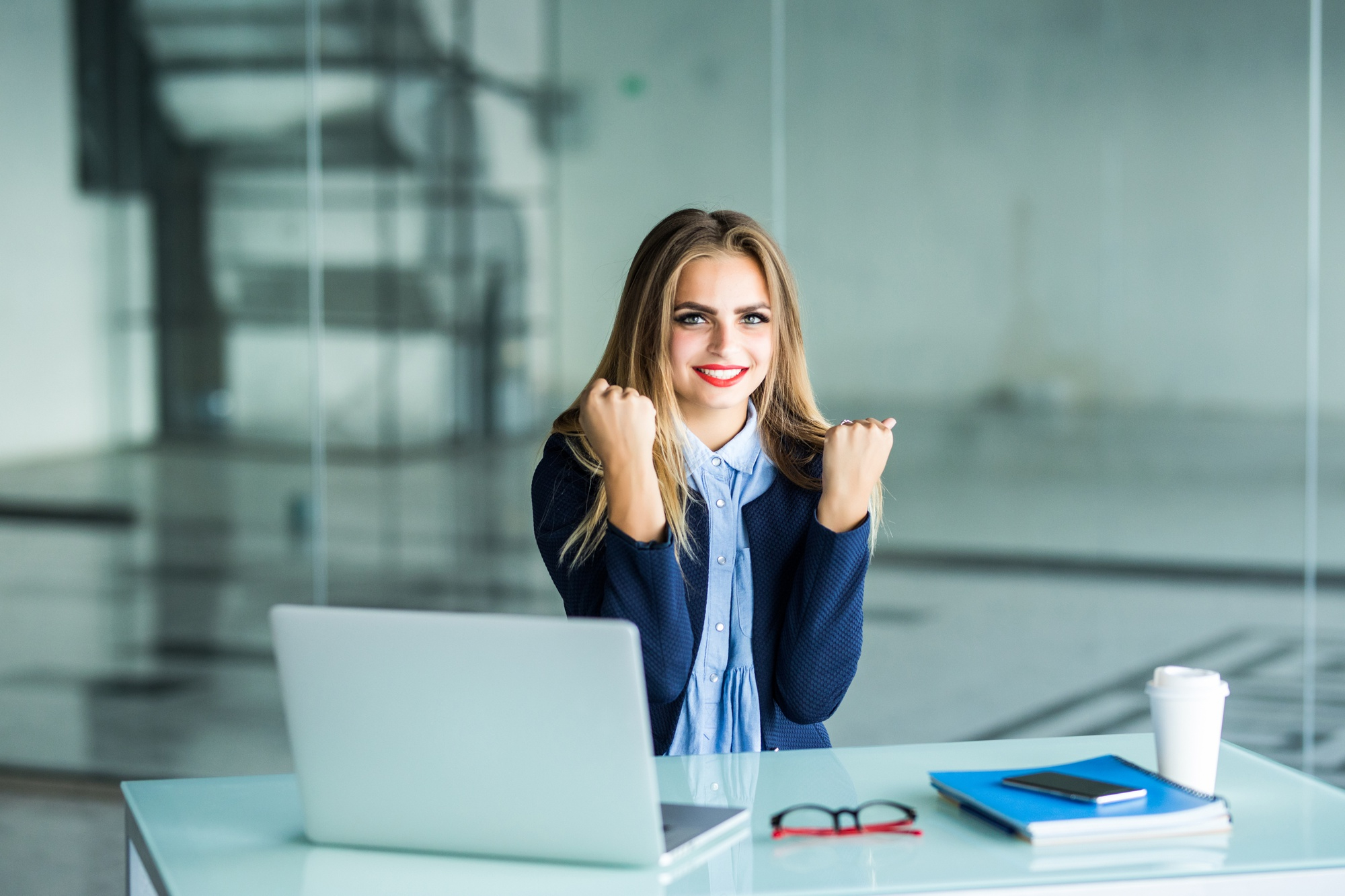 Triumphant Woman at a Computer