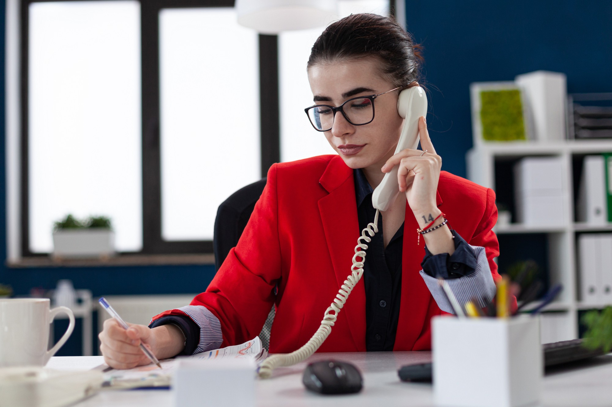 Woman on Phone Reviewing Notes