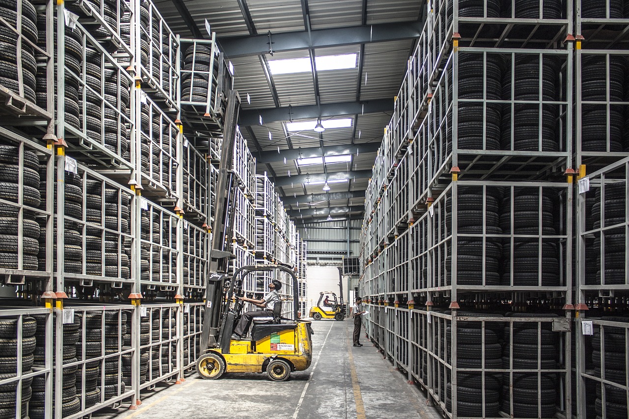 Forklift Moving Tires in Warehouse