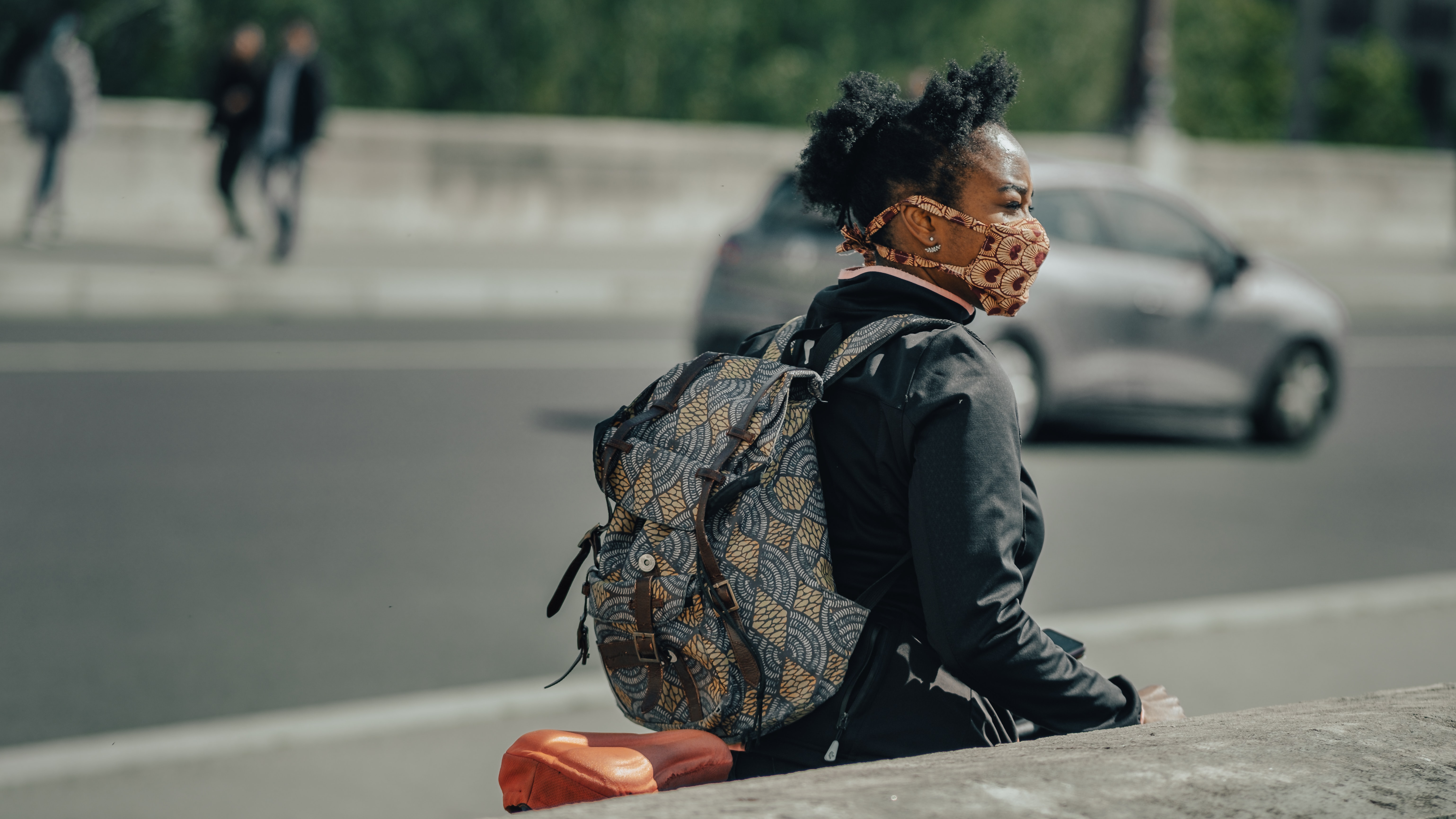 Woman Walking Down a Street with a Mask on Due to Coronavirus