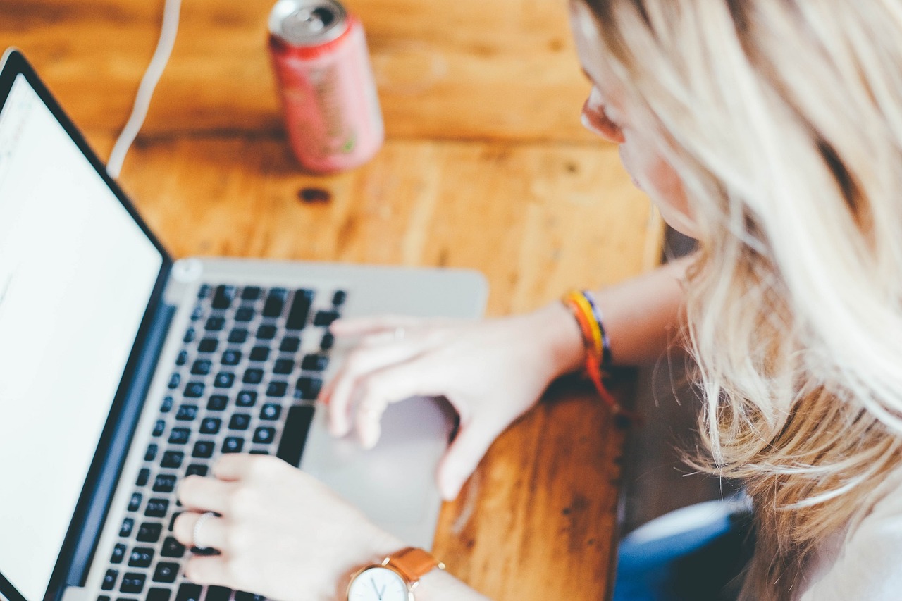 Woman Writing on a Laptop