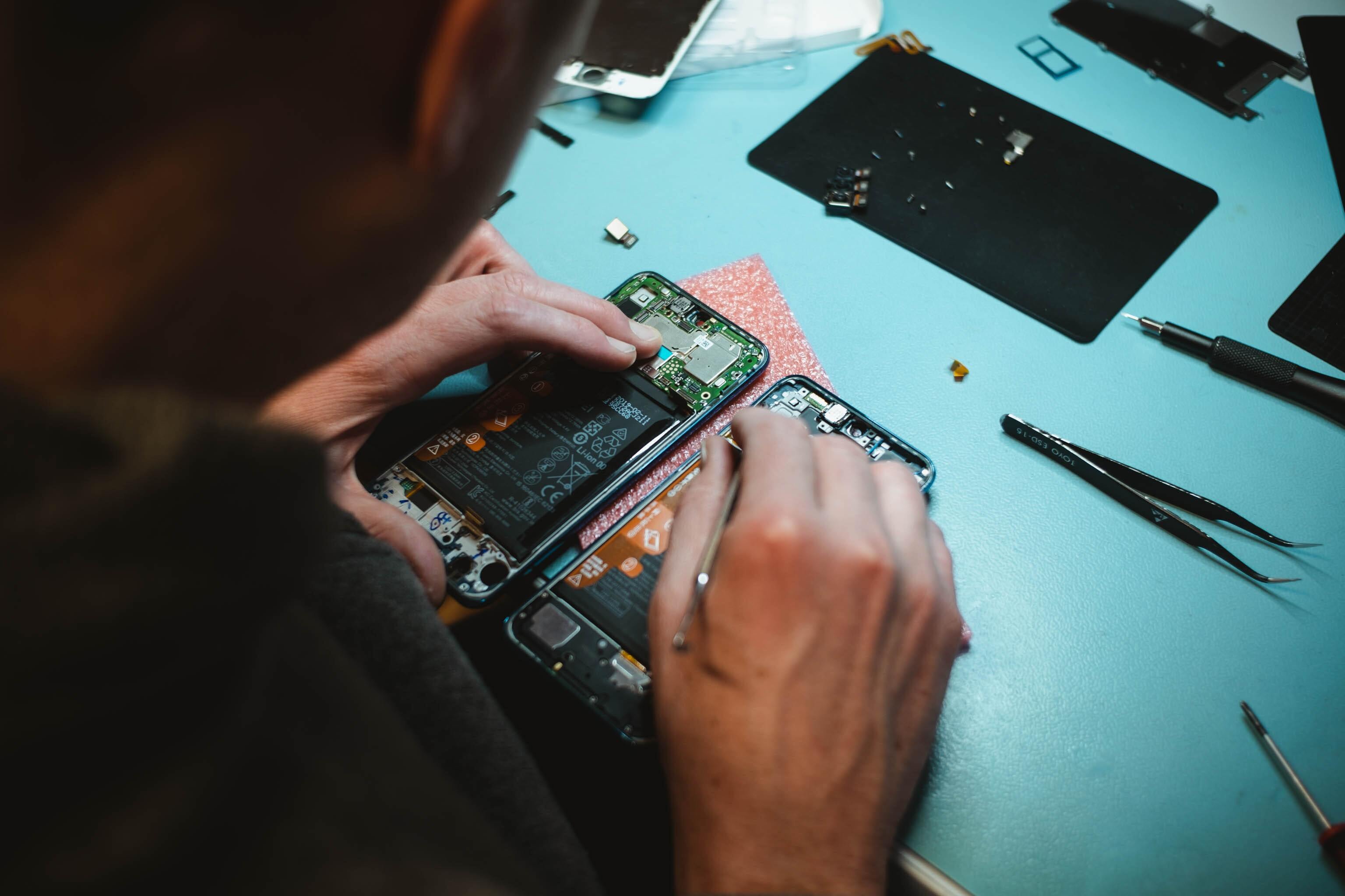 Man repairing smartphones