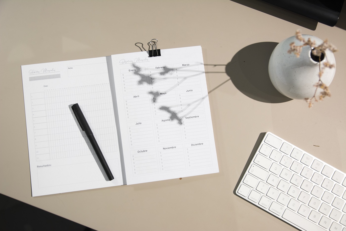 Personal calendar with a pen on top of it